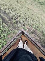 Standing on Rusty Platform Overlooking Grassy Landscape photo