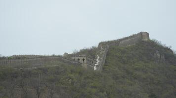 The broken watching tower built on the range of the mountains in China photo