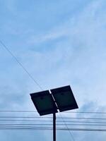 Silhouette of Solar Panel Against Cloudy Sky photo