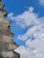 Plant Growing on Unique Stone Architecture Against Blue Sky. Seruni Point Bromo photo