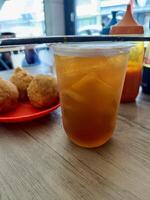 Iced Tea with Fried Snacks on a Wooden Table photo