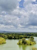 Scenic Lake with Islands and Dramatic Cloudy Sky. Bajulmati Dam Situbondo photo