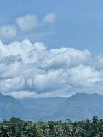Scenic Mountain Landscape with Fluffy Clouds photo