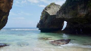 Scenic Coastal Rock Formations with Turquoise Waters. Suluban Beach Bali. photo