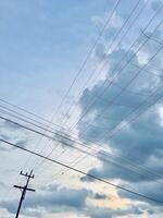 Intersecting Power Lines Against a Cloudy Sky photo