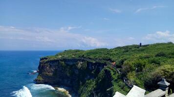 Cliffside Overlooking Ocean with Lush Greenery. Uluwatu Bali photo