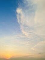 Soft Pastel Sunset with Wispy Clouds in a Tranquil Sky photo
