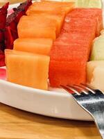Assorted Fresh Fruit Slices on a Plate photo