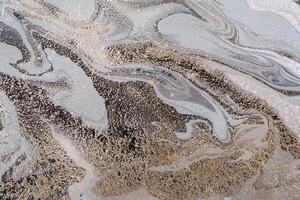 Abstract marble background or texture. Monochrome gray waves and gold particles pattern. Acrylic Fluid Art photo