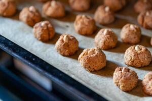 View of a lots of small nut cookies with whole almonds in the middle photo