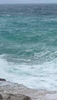 A stormy sea with crashing blue waves under dark clouds near the coast of Budva Montenegro. The powerful ocean swells and dramatic sky create a breathtaking display of natures force. video