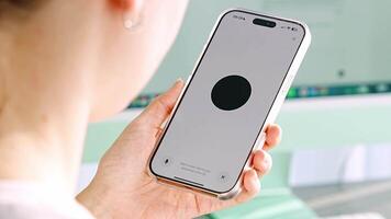 Prague, Czech republic - February 24, 2025. Back view of woman holding Iphone with Chat Gpt application on screen. Work assistant with Open Ai. Artificial Intelligence concept. video