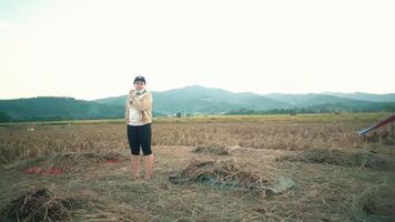 Woman in Rice Field with Mountains in Background video