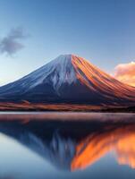 fiery sentinel bathed in morning light, tranquil setting reflected on golden hued serene lake at foot of volcanic mountain with rugged slopes, enveloped by brightness of new days sun photo