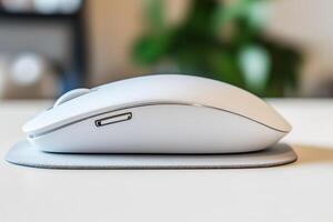Close-Up of a Modern Computer Mouse Resting on a Sleek Mouse Pad on a Minimal Desk Setup photo