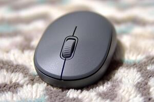 Close-Up View of a Gray Computer Mouse on a Textured Surface with Soft Colors and Patterns photo