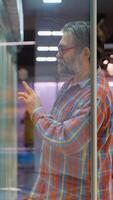 Senior man selecting eggs from refrigerated section in store video