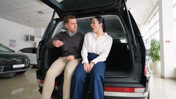 Happy couple dancing and hugging after buying new car video