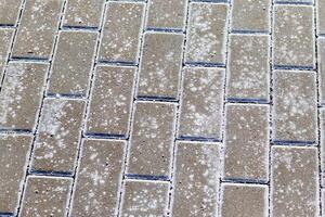 Interlock bricks with frost on them. Texture photo