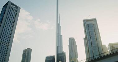 Bottom view from the window of a moving car to the tops of glass, skyscrapers against a clear blue sky in the business center of the city video