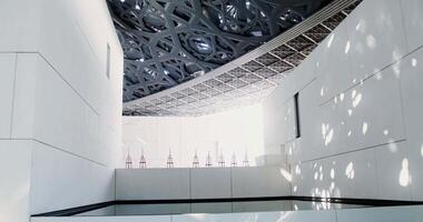 A white minimalistic museum building with empty easels on display. Abstract structure with an openwork ceiling video