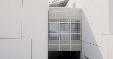 A small lattice covering the window of a modern building. The facade of a minimalistic abstract structure. Louvre Abu Dhabi video
