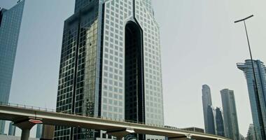Skyscrapers in the business center of a modern city, a view from the window of a car driving on the road video