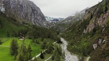 A valley with a small house in the middle of it video