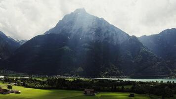 A beautiful view of a mountain range with a lake in the foreground video