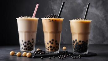 Three Types Of Bubble Tea In Clear Cups On Dark Background photo