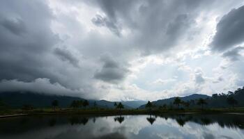 Dramatic Clouds Over Calm Lake with Palm Trees and Mountains photo