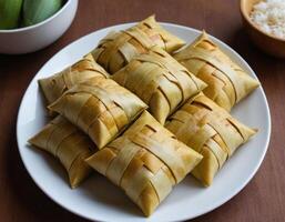 Traditional Square Food Wrapped in Palm Leaves photo