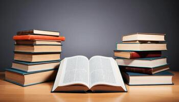 Stacked Books With Open Book On Wooden Table photo