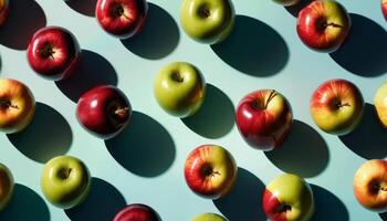 Red And Green Apples Patterned Arrangement On Light Blue Background photo