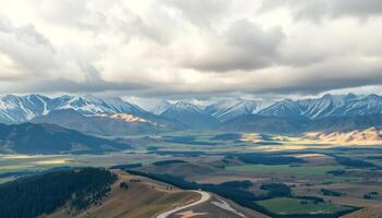 Panoramic Snow-Capped Mountains and Valley Landscape Under Cloudy Sky photo