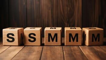 Wooden Blocks Spelling SMM on Dark Brown Wooden Table photo