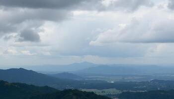 Panoramic Mountain Range Under a Cloudy Sky photo