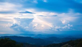 Mountain View Of City At Twilight With Dramatic Clouds photo