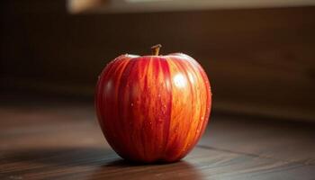 Red Apple with Water Drops on Dark Wood Table photo