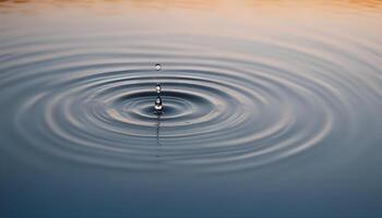 A drop of water falling into a pond photo