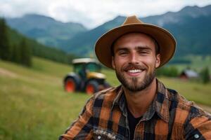 Smiling man in a hat enjoying a sunny day in the mountains with a tractor in the background photo