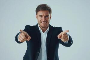 Confident man pointing and smiling in professional attire against a light background photo