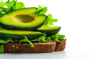 Fresh avocado slices on whole grain bread with leafy greens create vibrant and healthy sandwich. This colorful arrangement highlights nutritious ingredients beautifully photo