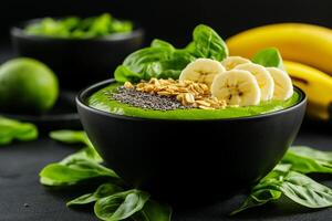 Fresh green smoothie bowl topped with banana, chia seeds, and granola, surrounded by fresh spinach and bananas, creating vibrant and healthy meal option photo