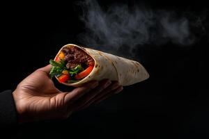 hand holding delicious wrapped fajita with fresh vegetables and smoke rising, creating appetizing and inviting atmosphere photo