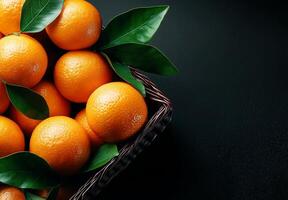 Fresh tangerines in wicker basket with green leaves on dark background, showcasing vibrant colors and natural textures. Perfect for healthy eating and decoration photo