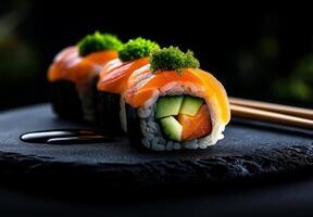 Sushi rolls with salmon, avocado, and cucumber on black plate, garnished with green toppings, create visually appealing dish perfect for food lovers photo