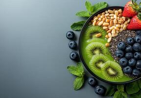 vibrant smoothie bowl featuring blueberries, strawberries, kiwi, and nuts, garnished with fresh mint leaves, perfect for healthy breakfast or snack photo