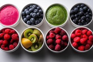 Colorful smoothie bowls and fresh fruits arranged in bowls create vibrant display. assortment includes blueberries, raspberries, kiwi, and green smoothie, evoking sense of freshness and health photo