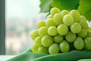 Fresh green grapes on green cloth with blurred background, showcasing their vibrant color and juicy texture, perfect for healthy snacking or culinary use photo